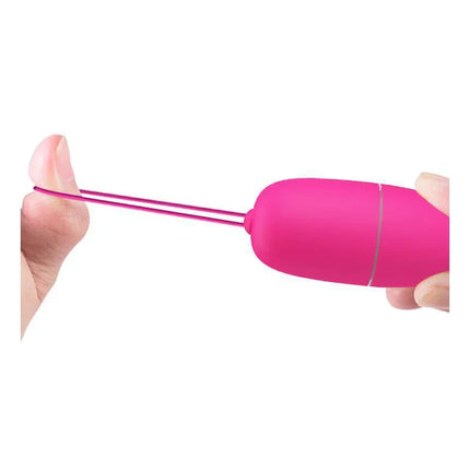 Selkie Vibrating Egg with Remote Control in pink, showcasing its compact design and flexible retrieval cord for discreet pleasure.
