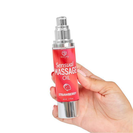 Hand holding Sensual Massage Oil Strawberry 50 ml bottle with pump dispenser, emphasizing silky texture and strawberry scent.