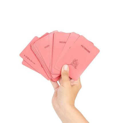 Hand holding cards from Sexmatch Game Bondage Edition, showcasing provocative challenges for couples.