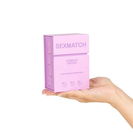 Sexmatch Game Foreplay Edition box set, a card game for couples, held in hand, featuring 89 playing cards and a guide card.