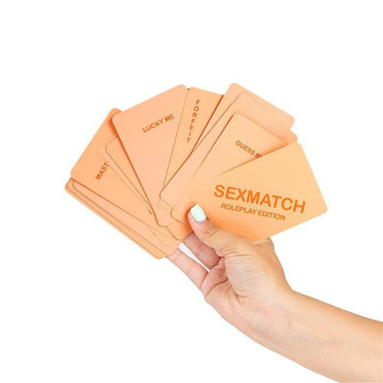 Hand holding a fan of Sexmatch Game Roleplay Edition cards showcasing game variety.