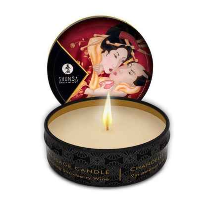 Shunga Mini Candle Massage Strawberry Wine in black tin, featuring Japanese art, with candlelight illuminating the scene.
