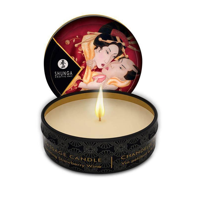 Shunga Mini Candle Massage Strawberry Wine in black tin, featuring Japanese art, with candlelight illuminating the scene.