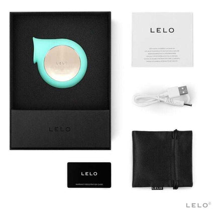 Complete package of Sila Cruise Clitoris Sucker Aqua by LELO, including massager, USB cable, pouch, and guide, laid out in box.