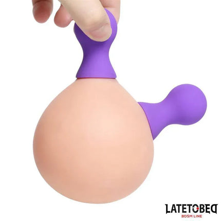 Silicone Nipple Suckers Purple suction device with a purple handle being demonstrated, body-safe and elegant for intimate moments.