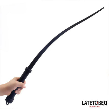 Silicone Whip 61 cm from Latetobed BDSM Line, held in hand showing smooth grip and flexible lashes.