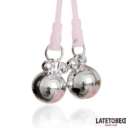 Skull Nipple Clamps with Ring Bells in pink with skull motif and shiny ring bells, perfect for playful and seductive moments.
