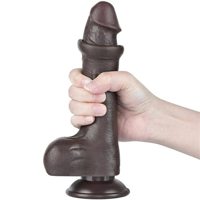 Person holding the Sliding Skin Dual Layer Dildo 8 showcasing its lifelike design and dual-layer texture with suction base.