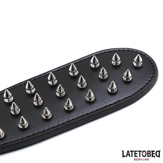 spiked bdsm paddle 30cm black leather paddle with metal spikes detail for intense impact play