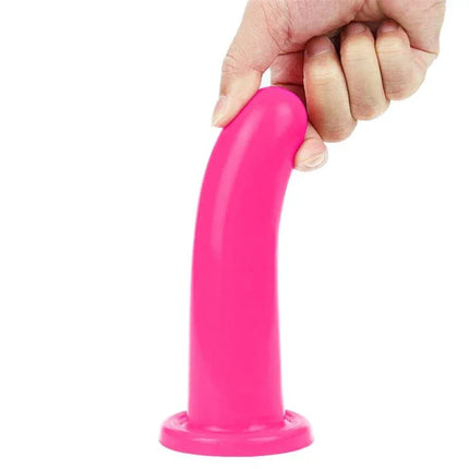 Stimulator Holy Dong 6 Liquid Silicone Pink in hand, showcasing the flexible silicone material and suction cup base for versatile use.