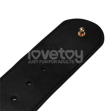 Close-up of strap from Strap On with Vibrating Dildo 9.5 harness set, featuring adjustable holes and secure snap detail