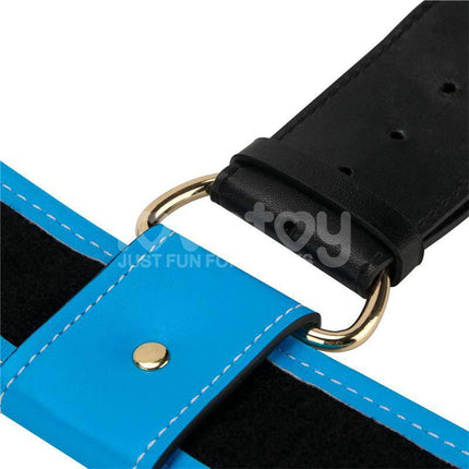 Close-up of a blue and black harness from the Strap On with Vibrating Dildo 9.5 featuring gold buckle accents.
