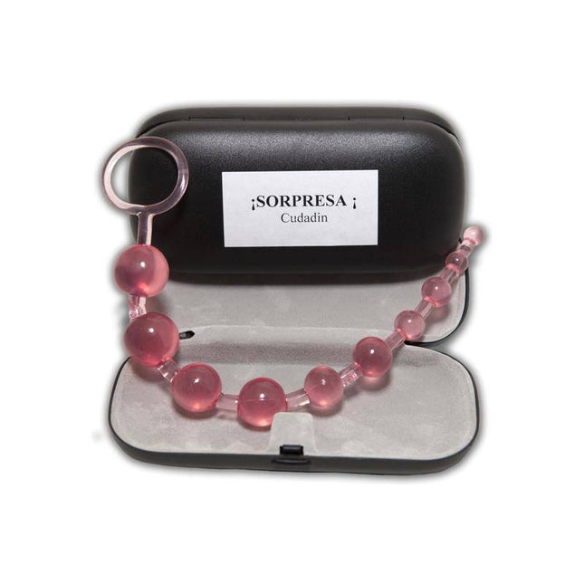 Pink beaded accessory with black "Surprise Cover Be Careful" case, open display view.