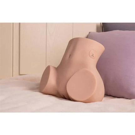 Sydni Masturbator with Thrusting 2.9 kg on a bed, featuring a realistic torso design, crafted from soft TPR for immersive solo play.