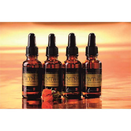 Tentation Woman to Woman Pheromones 30 ml bottles on a warm background, demonstrating the product designed for female attraction and connection.