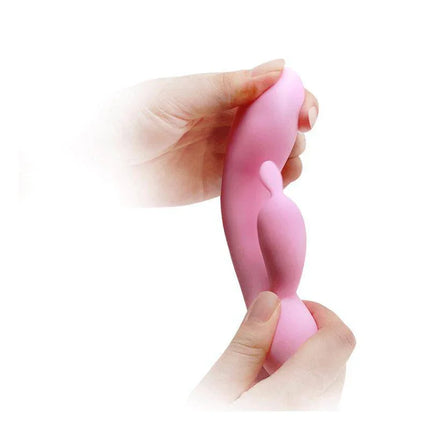 Hands holding Vibe Smart Hugo Memory Function silicone vibrator for G-spot and clitoral stimulation, pink color