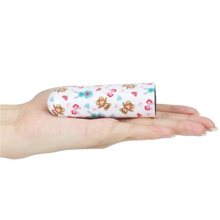 Vibrating Bullet Bear resting on hand, compact and portable design with teddy bear print, USB-rechargeable personal massager.