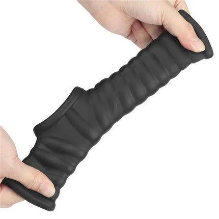 Flexible black textured product stretched by hands, showcasing a unique design for optimal use.
