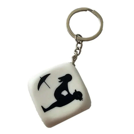 White Position Dice Keychain featuring silhouettes, compact design for playful and spontaneous adventures. Portable and unique.