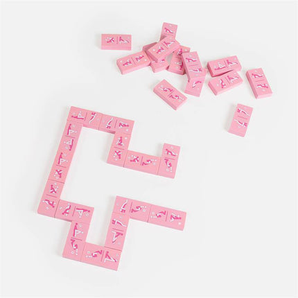 Wooden Game Kinky Domino pieces arranged on a white surface, showcasing playful illustrations on pink wooden tiles.