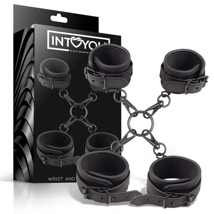 Wrist and Ankle Cuffs Set Vegan Leather with packaging, featuring black cuffs connected by metal rings for BDSM play.