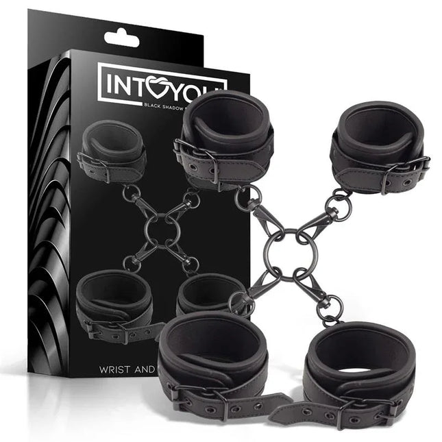 Wrist and Ankle Cuffs Set Vegan Leather with packaging, featuring black cuffs connected by metal rings for BDSM play.