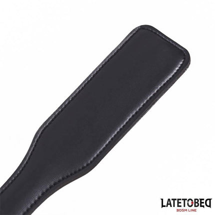 XOXO Paddle 32cm with a bold black design, ideal for intimate BDSM play, showing the detailed texture and comfortable grip.