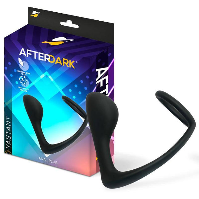 Yastant Anal Plug with Testicles Ring in black silicone by Afterdark, featuring a curved design and packaging box in the background